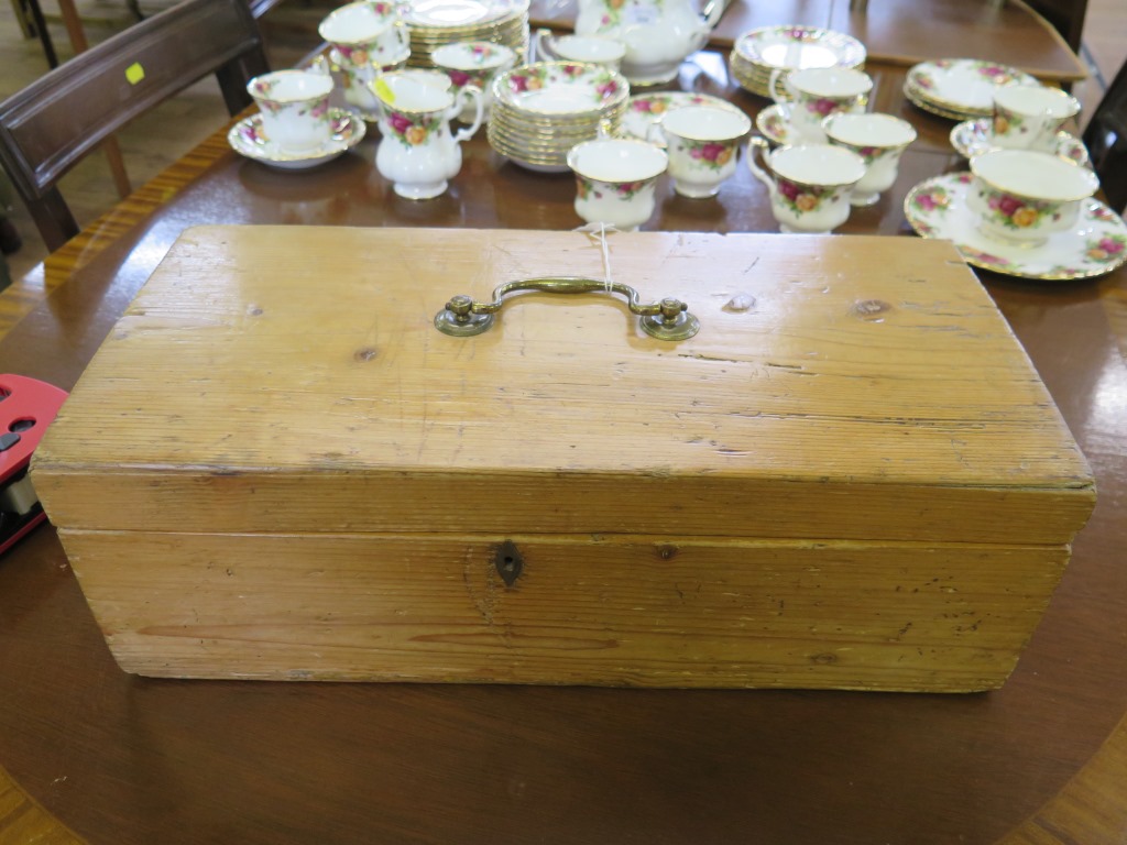 A pine box, with brass lid handle, 47cm long, 22cm wide, 15.5cm deep