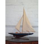 A red and blue painted model of a racing yacht 61cm long, 84cm high