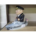 A Baistow Pottery figure of Winston Churchill on a battleship 17cm high