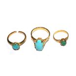 Three gold colour metal rings set with turquoise