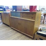 A White and Newton oak sideboard, 1950s, with two drawers beside a sliding glass panel over a pair