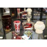 A Bohemian glass red and white overlay beaker 8cm, a red glass with gilt decoration 11cm, a red-