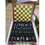 A mahogany cased golf theme chess set with gilt and silver finish metal figures with a 10 3/4"