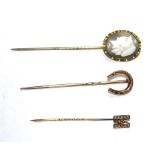 A collection of three stick pins to include a hardstone cameo head, etc