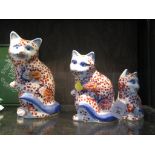 A set of three Japanese style graduated cat figures, tallest 21cm high