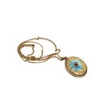 A gold colour locket decorated with blue enamel star on gold colour chain