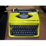 A yellow Antares 130 typewriter, and a Leitz Pradolux slide projector in original box (2)