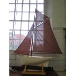A cream painted model of a sailing vessel with brown sails, hull 55cm long 109cm high