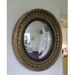 A Regency style giltwood convex mirror, with ebonised slip and ball applied frame, 57cm diameter