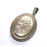 A large silver colour locket having initials to the front