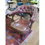 A late Victorian leather and walnut swivel office chair, the button upholstered back with fluted