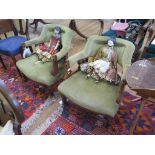 A pair of Edwardian upholstered tub armchairs, the backs with foliate carved splats over stuffed