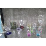 Drinking glasses including bonnet glass with blue rim, red bubble-foot with conical bowl, four