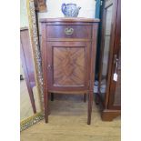 A 1920s mahogany bowfront bedside cabinet, the glass inset top over a drawer and cupboard door on