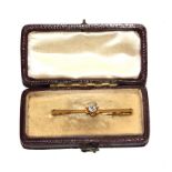 A bar brooch set with single diamond