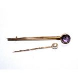 An amethyst tie pin and a pearl tie pin (2)