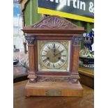 An early 20th century Hamburg America Clock Company walnut cased mantel clock, the arched shell