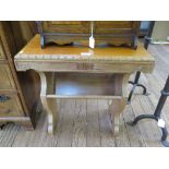 A Malaysian hardwood side table, the gadrooned top over floral carved supports joined by a