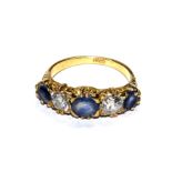 An 18 carat gold five stone sapphire and diamond ring