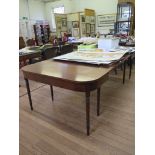 A George III style mahogany dining table, with rounded rectangular ends, two leaves and ring