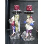 A pair of figural candlesticks in the form of elves shaving, stamped B.U. 1171 20cm high