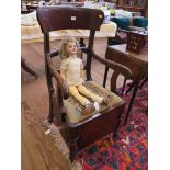 A Victorian mahogany commode chair, the ladder back over a drop in seat, deep frieze and bowl on