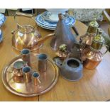 A large flat bottomed copper kettle 25cm high, a large conical copper vessel 27cm high, two copper