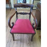 A Regency mahogany carver chair, with scroll carved mid rail, arms and sabre legs