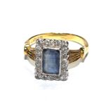 An 18 carat Art Deco ring set with diamonds and centre trap cut sapphire