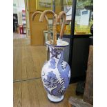 A large slipware baluster vase depicting a blue Chinese dragon, an ebonised torchere stand and