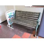 A cast iron garden bench, with lion head arm terminals and scrolling legs 130cm wide