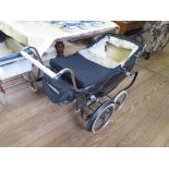 A black Silver Cross pram, 93cm long, and a Pedigree pram, similar (2)