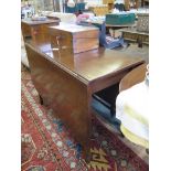 An Edwardian mahogany drop leaf table, the rectangular top with rounded corners on square tapering