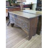 A 17th century style oak coffer, of planked construction, with hinged lid and lozenge carved