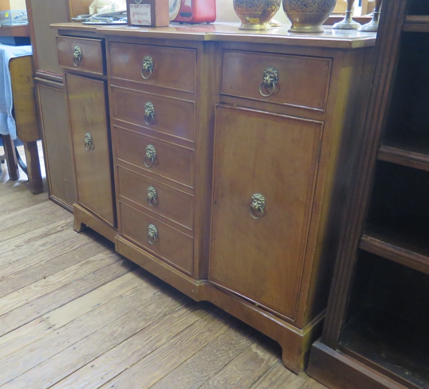 A reproduction mahogany breakfront side cabinet, the three frieze drawers over a dummy drawer