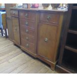 A reproduction mahogany breakfront side cabinet, the three frieze drawers over a dummy drawer