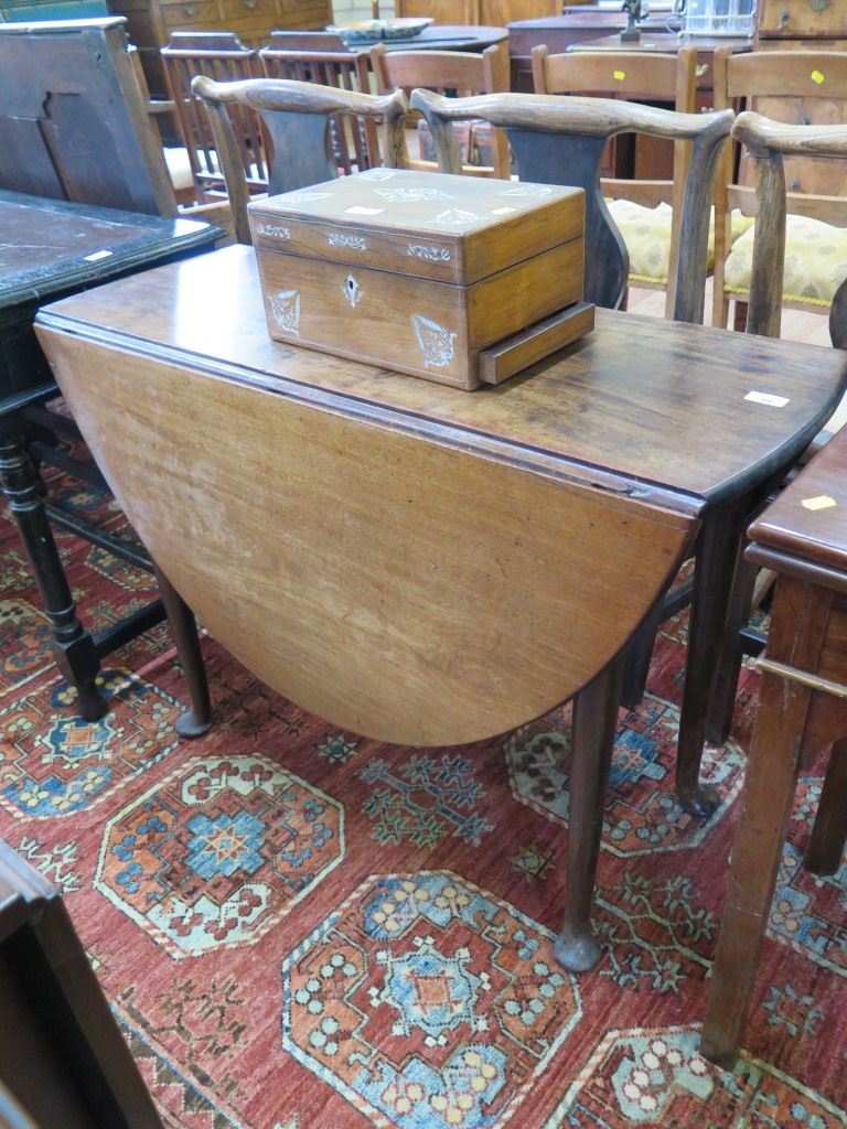 A George II style mahogany dropleaf table, the oval top on turned tapering legs with club feet,