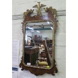 A George II style walnut parcel gilt fret carved wall mirror, with hoho bird surmount and foliate