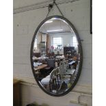 A pewter framed oval wall mirror with bevelled plate, 79 x 55cm