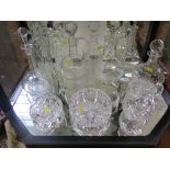Eight glass decanters, a jug and two cut glass ashtrays