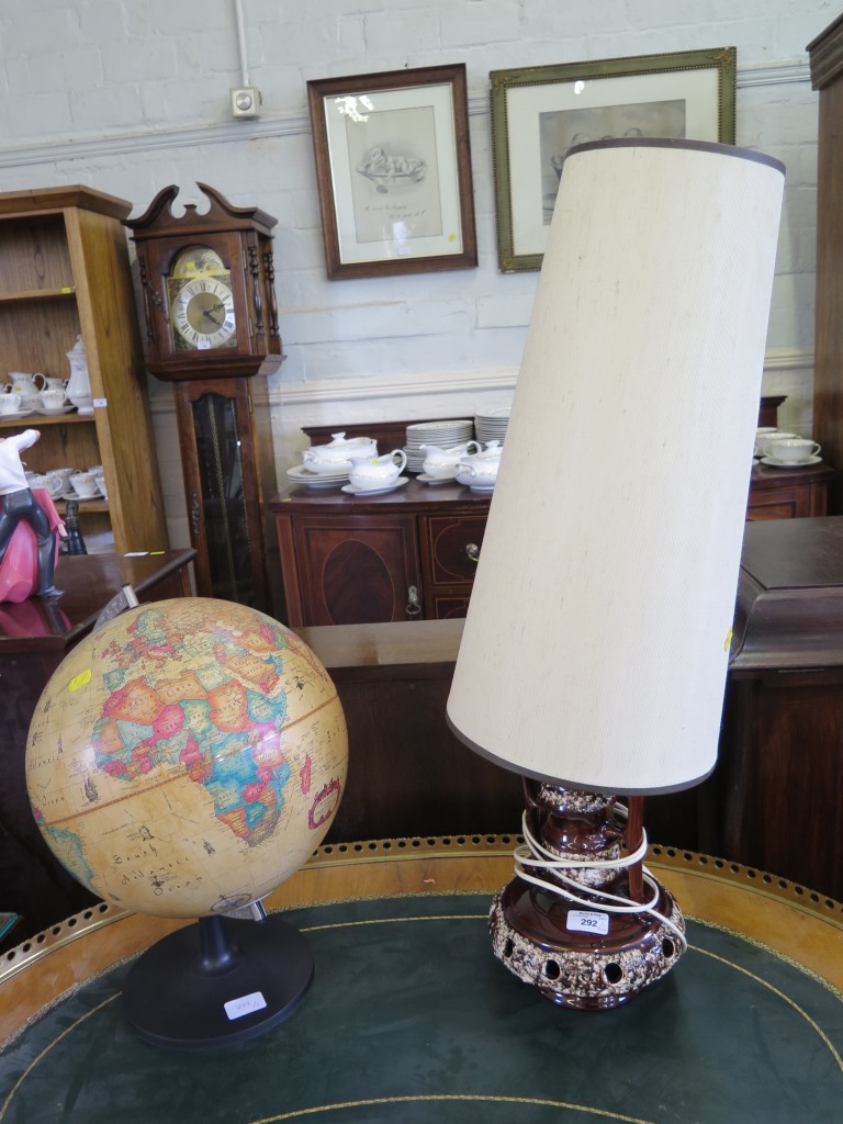 A 1970s brown glaze table lamp, a World Discoverer globe and a picnic hamper (3)