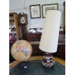A 1970s brown glaze table lamp, a World Discoverer globe and a picnic hamper (3)