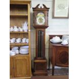 A mahogany longcase clock by Emperor, the broken arch over a brass dial and glazed trunk door, the