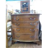 A crossbanded mahogany bowfront chest of drawers with brush slide and four long graduated drawers on