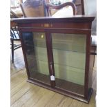 An inlaid mahogany collector's cabinet with bevelled glass doors and glass shelves, 73cm wide 20cm