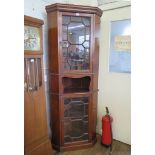 An Edwardian mahogany corner cabinet, the moulded cornice over two astragal glazed doors and open