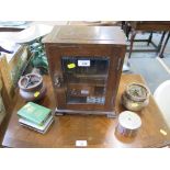 An oak smoker's cabinet, 33cm high, pipes and two tobacco jars and three savings boxes