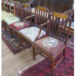 A set of four Edwardian inlaid mahogany dining chairs, the ribbon and husk top rails over rail