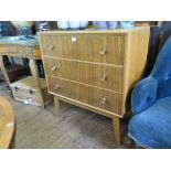 A 1950s oak and teak chest of drawers with three long drawers, 76cm wide