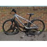 A Shogun Cult mountain bike in silver and black with padlock, two keys and pump